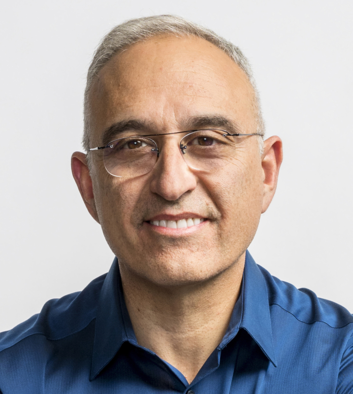 Antonio Neri, President and CEO of HPE, looks to camera wearing a blue dress shirt and glasses.