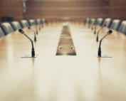 Empty boardroom table. Who will get a seat in ESG discussions?