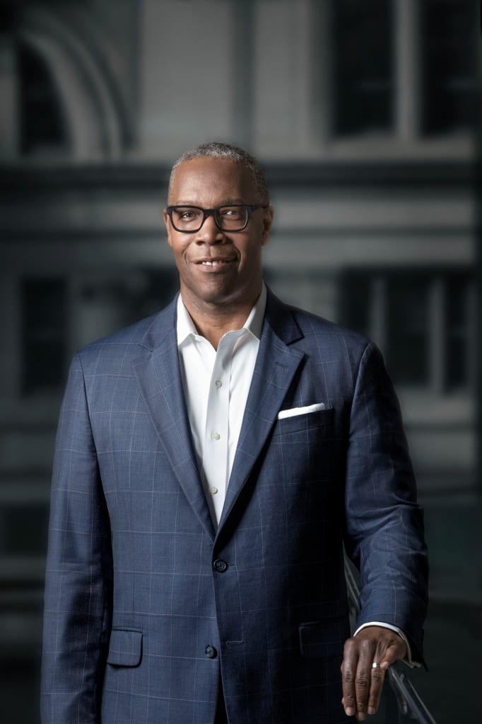David S. Huntley, SEVP & Chief Compliance Officer of AT&T Inc., stands in a suit, facing camera. Huntley is one of the nation's leading Black executives.
