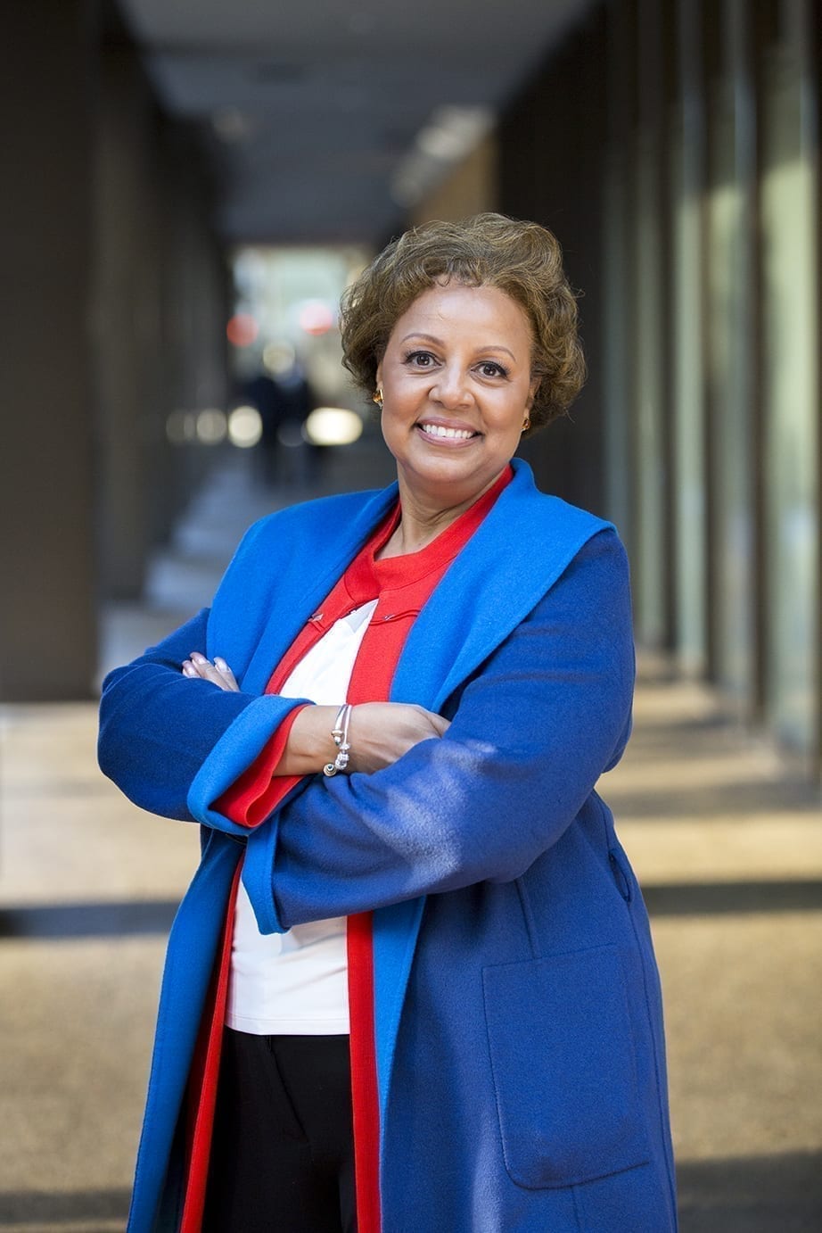 Hope Scott, VP, Chief Risk & Compliance Officer for Blue Shield of California, stands in a red and blue ensemble. She will discuss how companies should survey to combat #MeToo problems.